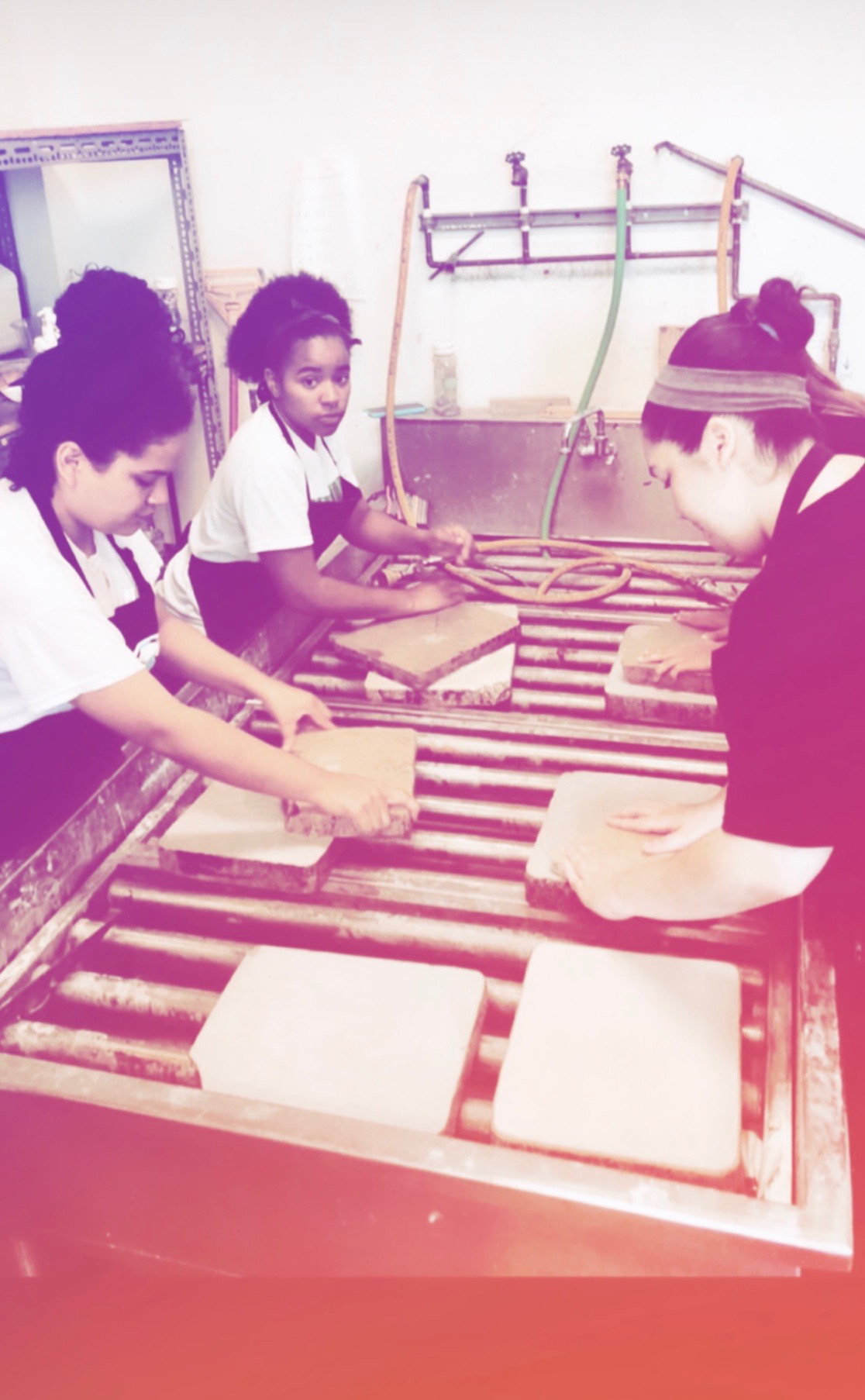 printmaking students graining limestone plates